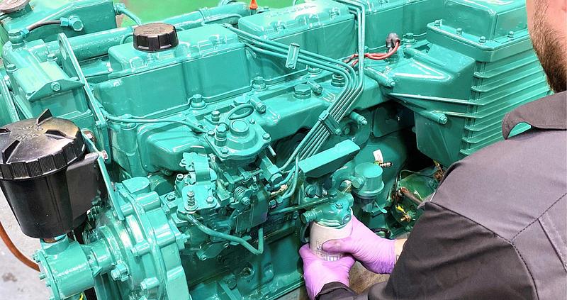 Engineer refurbishing diesel engine